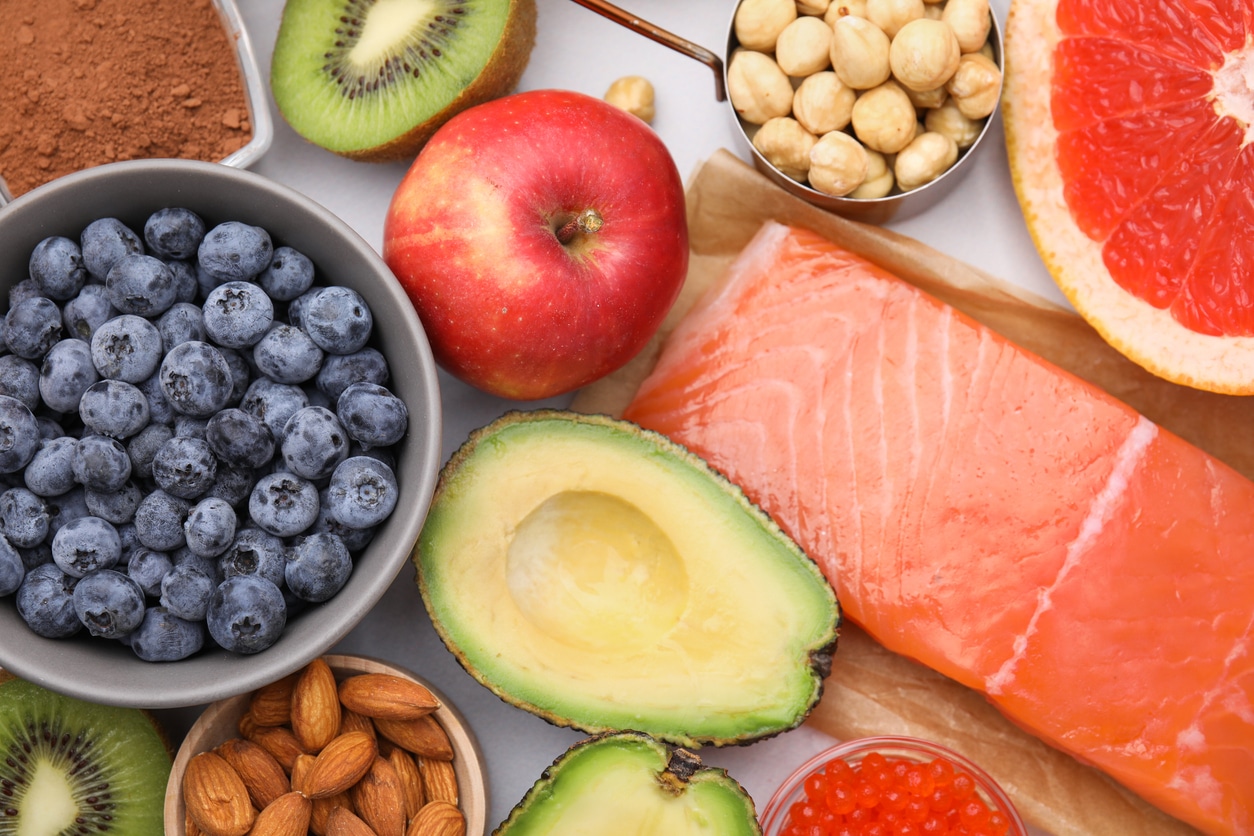 Many different healthy foods on white table, flat lay